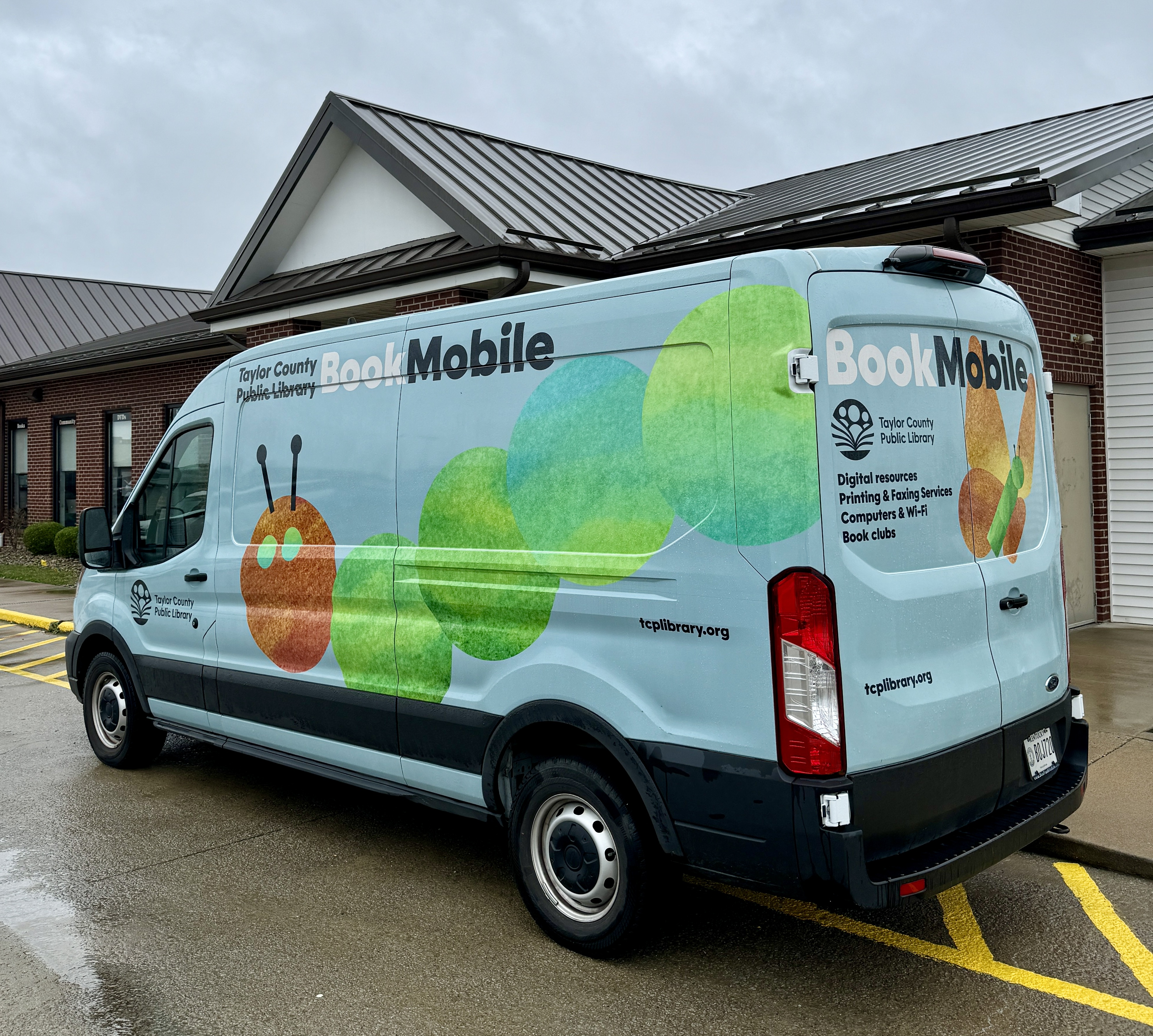 Bookmobile beside the library