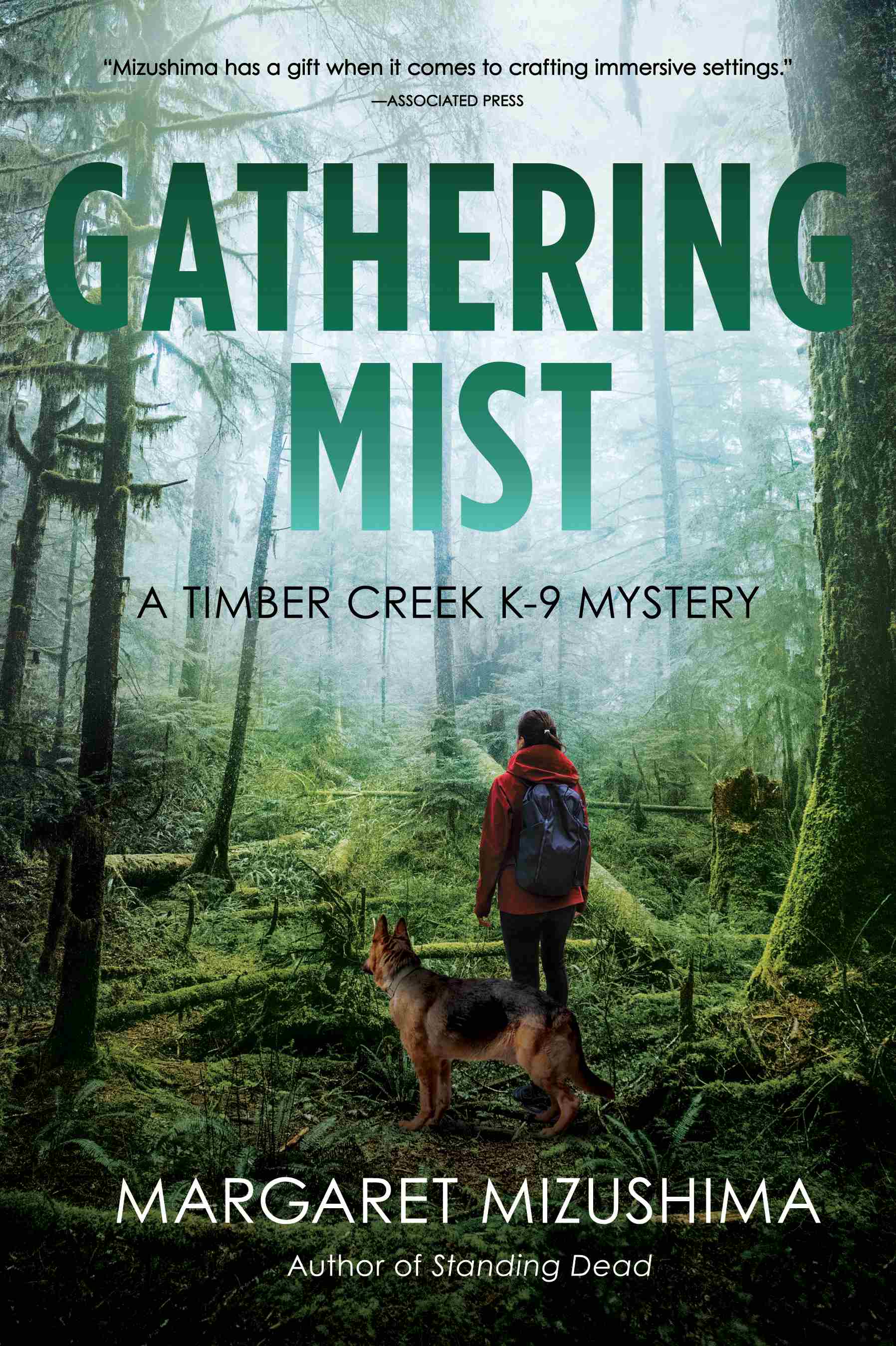 Timber Creek K-9 Mystery #9 - Gathering Mist - a woman walking in a dark green forest