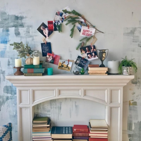 a festive holiday card display made with pieces of wood and clothespins 