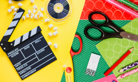 Makers Movie Night Promotional Image - half the screen has a yellow background with a cinema board with popcorn and a movie reel; the over the half has a background of green, red, and light green craft paper with two pairs of scissors and pencils