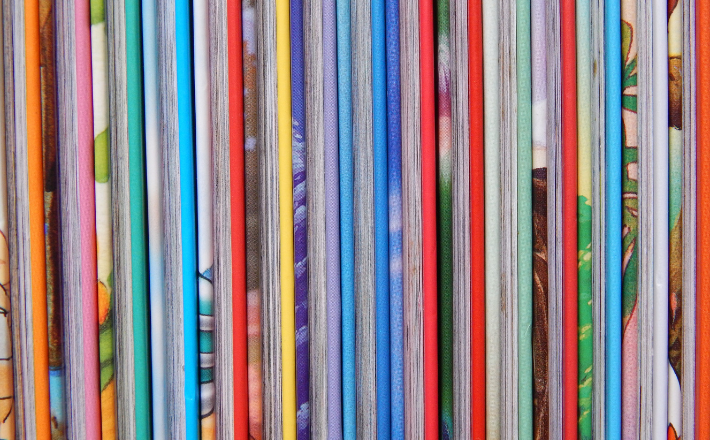 a picture of the side of books featuring their pages and colorful hardbacks