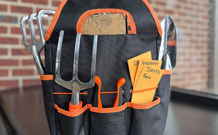 Gardening Bag with gardening tools, featuring our seed catalog